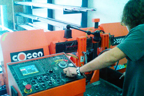 AK Machining specialist operating a saw