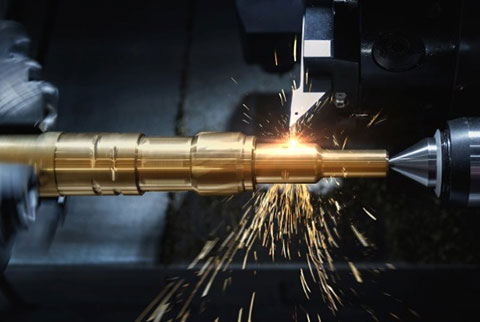 AK Machining specialist operating a saw